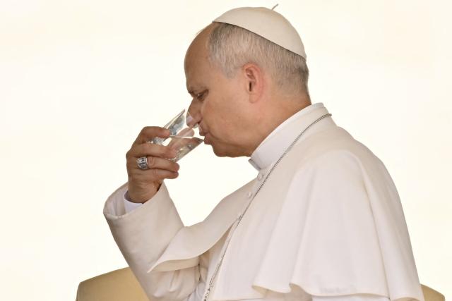 (FILES) Pope Leo XIV drinks a glass of water at the end of the weekly general audience at St Peter's Square in The Vatican during a heatwave on June 24, 2026. Pope Leo XIV will be admitted to hospital on October 13, 2026 for an operation to remove a lump from his lung, the Vatican said. The 71-year-old Leo announced on October 11, 2026 after his weekly prayers that he would undergo an operation "in the coming days". (Photo by Filippo MONTEFORTE / AFP)