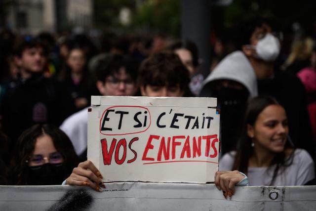A protester holds a placard reading "what if it was your children?" during a demonstration of high-school students in Lyon, southeastern France on October 13, 2026, as part of a nationwide high school mobilisation. France readied on October 13 for fresh nationwide demonstrations supporting students who have been protesting poor classroom conditions for weeks, with authorities and participants wary of further violence. (Photo by JEFF PACHOUD / AFP)