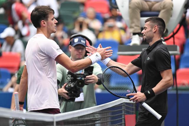 France’s Arthur Gea (R) shakes hands with Czech Republic’s Jakub Mensik after their men's singles match at the Shanghai Masters tennis tournament in Shanghai on October 13, 2026. (Photo by CN-STR / AFP) / China OUT