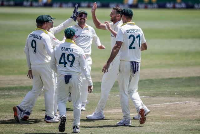 Australia's Josh Hazlewood (2nd R) celebrates with his teammates after dismissing South Africa's Wiaan Mulder on day five of the first Test match between South Africa and Australia at the Kingsmead stadium in Durban on October 13, 2026. (Photo by Marco Longari / AFP)