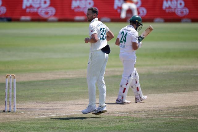 Australia's Josh Hazlewood celebrates after dismissing South Africa's Wiaan Mulder (R) on day five of the first Test match between South Africa and Australia at the Kingsmead stadium in Durban on October 13, 2026. (Photo by Marco Longari / AFP)