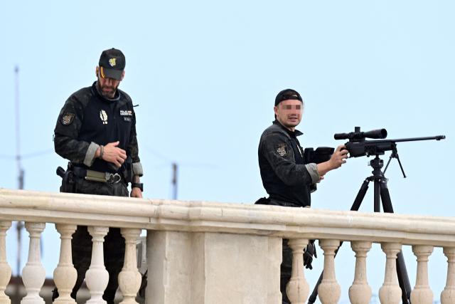 Police snipers take position on a rooftop before the arrival of Spain's King Felipe VI and Queen Letizia in the Spanish North African enclave of Ceuta, on October 13, 2026. Spain's King Felipe VI and Queen Letizia make a diplomatically sensitive visit to Ceuta today in support of a city mired in crisis since July's migrant rush from Morocco. Their trip will mark the first royal visit since 2007 when a diplomatic crisis erupted with neighbouring Morocco, which claims sovereignty over Ceuta and Spain's other North African territory of Melilla. (Photo by Antonio Sempere / AFP)