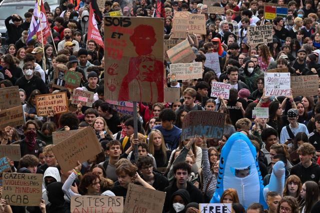 Protesters holds a placard which reads as 'Be young and shut up' (C) while taking part in a demonstration of high-school students in Nantes, western France on October 13, 2026, as part of a nationwide high school mobilisation over learning conditions. France sees nationwide demonstrations on October 13 in support of students protesting poor classroom conditions for weeks, as authorities and participants remain wary of further violence. (Photo by Sebastien Salom-Gomis / AFP)