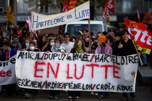 Protesters and students hold slogans and banners during a demonstration in Brest, western France on October 13, 2026, as part of a nationwide high school mobilisation. France sees nationwide demonstrations on October 13 in support of students protesting poor classroom conditions for weeks, as authorities and participants remain wary of further violence. (Photo by FRED TANNEAU / AFP)
