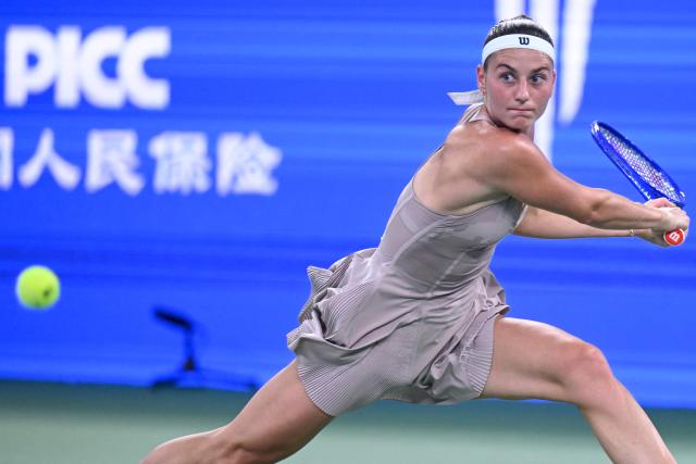 Ukraine's Marta Kostyuk hits a return to Greece's Maria Sakkari during their women’s singles match at the Wuhan Open tennis tournament in Wuhan, China's Hubei province on October 13, 2026. (Photo by WANG Zhao / AFP)