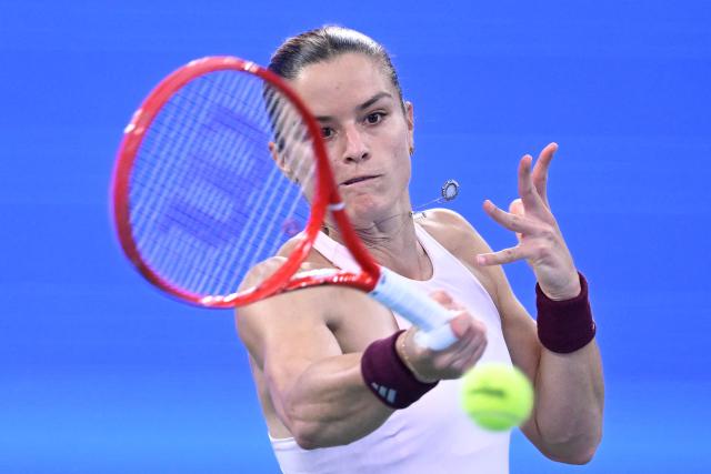 Greece's Maria Sakkari hits a return to Ukraine's Marta Kostyuk during their women’s singles match at the Wuhan Open tennis tournament in Wuhan, China's Hubei province on October 13, 2026. (Photo by WANG Zhao / AFP)