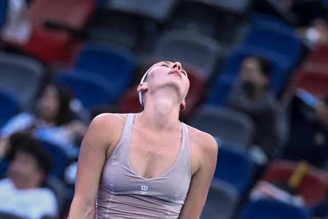 Ukraine's Marta Kostyuk reacts during her women’s singles match against Greece's Maria Sakkari at the Wuhan Open tennis tournament in Wuhan, China's Hubei province on October 13, 2026. (Photo by WANG Zhao / AFP)