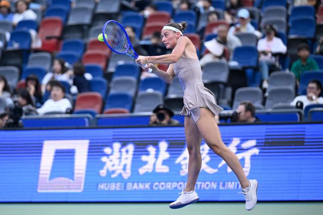 Ukraine's Marta Kostyuk hits a return to Greece's Maria Sakkari during their women’s singles match at the Wuhan Open tennis tournament in Wuhan, China's Hubei province on October 13, 2026. (Photo by WANG Zhao / AFP)