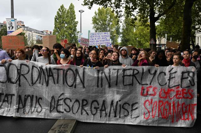 Young protesters hold a placard which read as 'You are not serious when you are 17, but we fight for our commitments' (C), while taking part in a demonstration of high-school students in Nantes, western France on October 13, 2026, as part of a nationwide high school mobilisation over learning conditions. France sees nationwide demonstrations on October 13 in support of students protesting poor classroom conditions for weeks, as authorities and participants remain wary of further violence. (Photo by Sebastien Salom-Gomis / AFP)