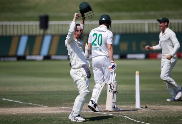 Australia's Travis Head (L) celebrates after the dismisal of South Africa's Anrich Nortje (C/20) to seal victory for Australia on day five of the first Test match between South Africa and Australia at the Kingsmead stadium in Durban on October 13, 2026. (Photo by Marco Longari / AFP)