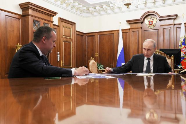 In this pool photograph distributed by the Russian state agency Sputnik, Russia's President Vladimir Putin meets with Russian Minister of Transport Andrey Nikitin in Moscow on October 13, 2026. (Photo by Mikhail METZEL / POOL / AFP)