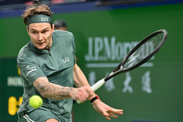 Kazakhstan's Alexander Bublik hits a return to Germany's Alexander Zverev during their men's singles match at the Shanghai Masters tennis tournament in Shanghai on October 13, 2026. (Photo by Hector RETAMAL / AFP)