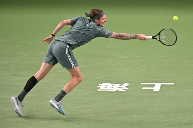 Kazakhstan's Alexander Bublik hits a return to Germany's Alexander Zverev during their men's singles match at the Shanghai Masters tennis tournament in Shanghai on October 13, 2026. (Photo by Hector RETAMAL / AFP)