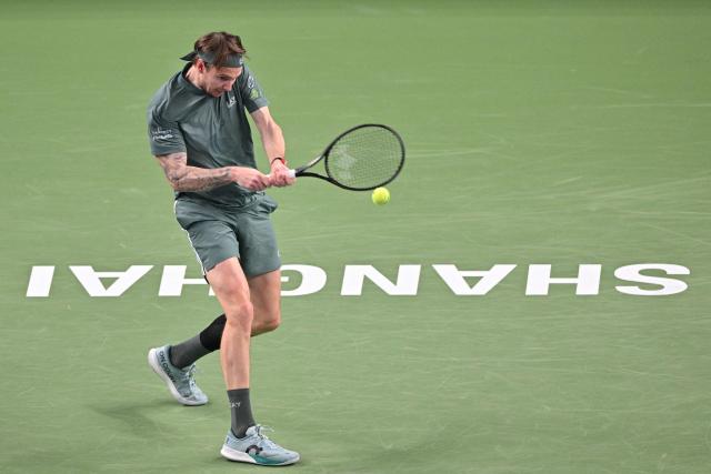 Kazakhstan's Alexander Bublik hits a return to Germany's Alexander Zverev during their men's singles match at the Shanghai Masters tennis tournament in Shanghai on October 13, 2026. (Photo by Hector RETAMAL / AFP)