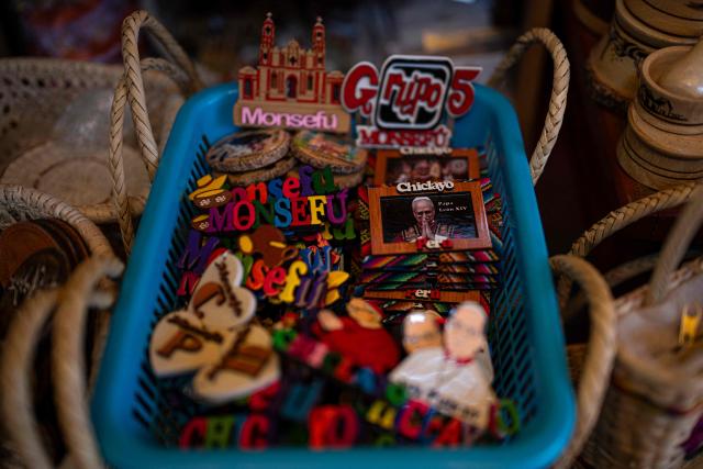 This image shows memorabilia for sale regarding the upcoming visit of Pope Leo XIV at a store in the Lambayeque department, near Chiclayo, northern Peru, on October 12, 2026. Pope Leo XIV was admitted to hospital on October 13, 2026, for surgery to remove a lump from his lung, the Vatican said. He is expected to recover from the operation in time for the 11-day official trip to Latin America, that will see him visit Uruguay, Argentina and Peru. (Photo by Ernesto BENAVIDES / AFP)