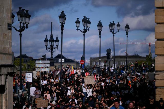 Protesters hold placards during a demonstration of high-school students in Bordeaux, southwestern France on October 13, 2026, as part of a nationwide high school mobilisation. France sees nationwide demonstrations on October 13 in support of students protesting poor classroom conditions for weeks, as authorities and participants remain wary of further violence. (Photo by Christophe ARCHAMBAULT / AFP)