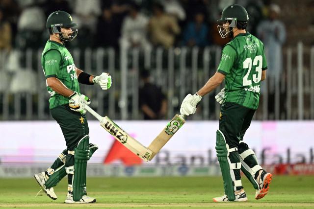 Pakistan's captain Sahibzada Farhan (L) celebrates with Arafat Minhas after scoring a half-century (50 runs) during the third T20 international cricket match between Pakistan and Sri Lanka at the Rawalpindi Cricket Stadium in Rawalpindi on October 13, 2026. (Photo by FAROOQ NAEEM / AFP)