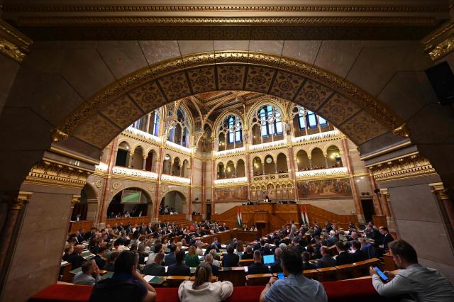 (FILES) A general view taken on June 23, 2026 shows members of parliament in the main hall of Parliament during an extraordinary session of the National Assembly. Hungarian lawmakers on October 13, 2026 voted to remove anti-LGBTQ provisions in a 2021 "child protection" law adopted under nationalist ex-leader Viktor Orban. Parliament passed a bill with 139 votes in favour and 51 votes against, marking the first significant reversal of Orban's curbs targeting the LGBTQ community since pro-EU Prime Minister Peter Magyar took power in May 2026. (Photo by Attila KISBENEDEK / AFP)