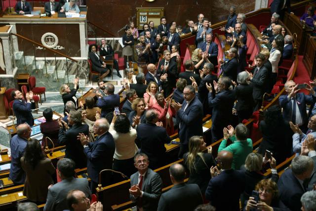 Members of Parliament applaud after the vote on the comprehensive law on gender-based and sexual violence at the National Assembly, French Parliament's lower house, in Paris on October 13, 2026. The National Assembly has unanimously passed the comprehensive bill aimed at combating sexual and gender-based violence. (Photo by Thomas SAMSON / AFP)