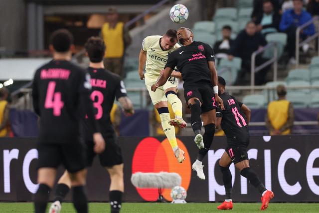 Slavia Prague's Czech defender #27 Tomas Vlcek and Sabah FK's Rwandan forward #20 Joy-Lance Mickels vie for the ball during the UEFA Champions League match between Sabah and Slavia Praha at the Baku Olympic Stadium in Baku on October 13, 2026. (Photo by Giorgi ARJEVANIDZE / AFP)