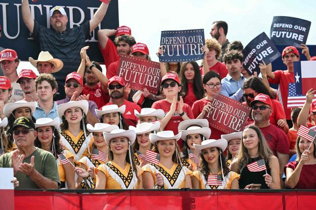 Audience members cheer as US Vice President JD Vance (out of frame) speaks during a campaign rally at Tyler Pounds Regional Airport  in Tyler, Texas, on October 13, 2026. Vance is campaigning for several Republican candidates on the November midterm ballot. (Photo by SAUL LOEB / POOL / AFP)