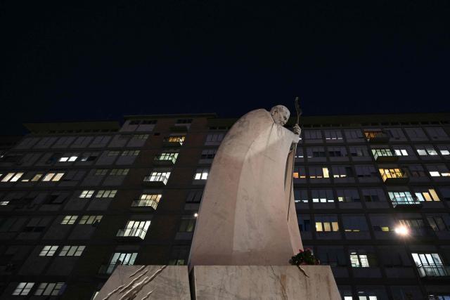 A picture shows the statue of John Paul II outside Rome's Gemelli University Hospital, where Pope Leo XIV has been admitted for an operation to remove a lump from his lung, on 13 October 2026.  (Photo by Andreas SOLARO / AFP)