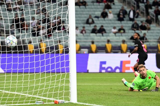 Slavia Prague's Czech goalkeeper #35 Jakub Markovic concedes a goal scored by Sabah FK's Jamaican midfielder #11 Kaheem Parris which was later disallowed for an offside after a VAR check during the UEFA Champions League match between Sabah and Slavia Praha at the Baku Olympic Stadium in Baku on October 13, 2026. (Photo by Tofik BABAYEV / AFP)