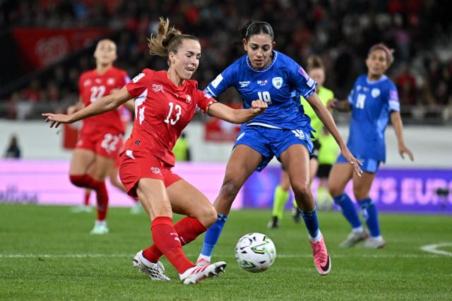 Switzerland's midfielder #13 Lia Walti kicks the ball next to Israel's forward #19 Maria Almasri during the Women’s FIFA World Cup 2027 qualifyers play-off football match between Switzerland and Israel at Stade de Tourbillon in Sion, Switzerland, on October 13, 2026. (Photo by Fabrice COFFRINI / AFP)
