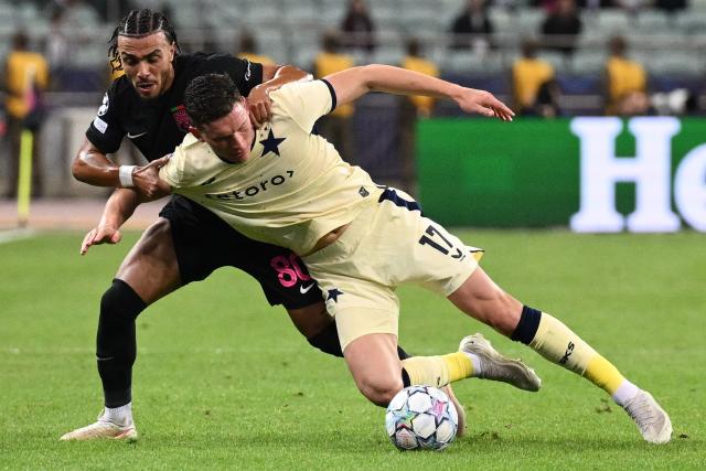 Sabah FK's Algerian defender #80 Akim Zedadka and Slavia Prague's Czech midfielder Lukas Provod vie for the ball during the UEFA Champions League match between Sabah and Slavia Praha at the Baku Olympic Stadium in Baku on October 13, 2026. (Photo by Tofik BABAYEV / AFP)