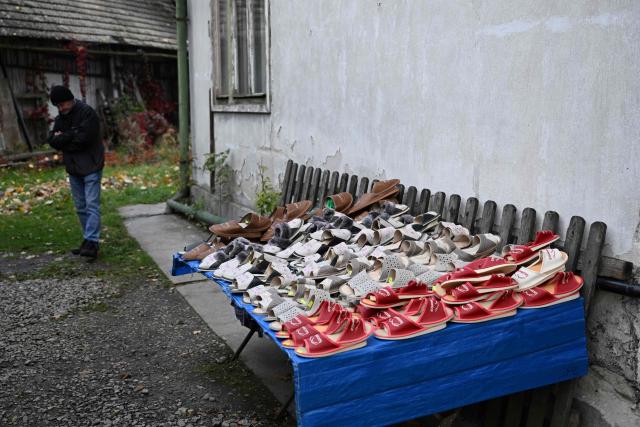A local resident sells handmade shoes on a street in Szczawnica, Lesser Poland Voivodeship on October 13, 2026. (Photo by Sergei GAPON / AFP)