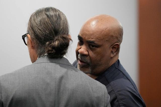 Duane Davis (R) speaks with his attorney Michael Sanft during his sentencing hearing in the 1996 killing of rapper Tupac Shakur, at Clark County District Court at the Regional Justice Center in Las Vegas, Nevada, on October 13, 2026. Davis, a former Los Angeles gang member, will be sentenced today after being found guilty on August 31, 2026 by a Las Vegas court, thirty years after the rap legend's death in Las Vegas. (Photo by John Locher / POOL / AFP)