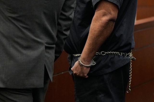 Duane Davis, right, talks stands with his attorney Michael Sanft during his sentencing hearing in the 1996 killing of rapper Tupac Shakur, at Clark County District Court at the Regional Justice Center in Las Vegas, Nevada, on October 13, 2026. Davis, a former Los Angeles gang member, will be sentenced today after being found guilty on August 31, 2026 by a Las Vegas court, thirty years after the rap legend's death in Las Vegas. (Photo by John Locher / POOL / AFP)