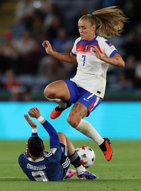 England's midfielder #07 Georgia Stanway jumps a challenge from Greece's defender #09 Eleni Markou during the Women's FIFA world cup qualifications second leg semi-final football match between England and Greece at King Power stadium, in Leicester on October 13, 2026. (Photo by Darren Staples / AFP)