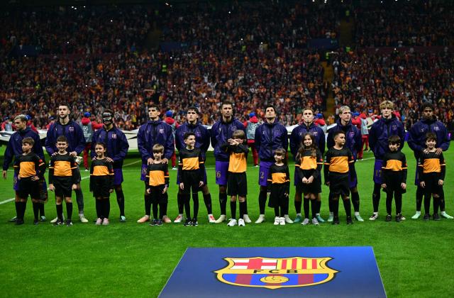 Barcelona's players stand with mascots for the UEFA anthem ahead of the UEFA Champions League, league phase matchday 2, football match between Galatasaray and Barcelona at the Ali Sami Yen Sports Complex in Istanbul on October 13, 2026. (Photo by YASIN AKGUL / AFP)