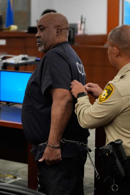 Duane Davis (L), is escorted by police from a sentencing hearing after his murder conviction in the 1996 killing of rapper Tupac Shakur, at Clark County District Court at the Regional Justice Center in Las Vegas, Nevada, on October 13, 2026. Davis, a former Los Angeles gang member, will be sentenced today after being found guilty on August 31, 2026 by a Las Vegas court, thirty years after the rap legend's death in Las Vegas. (Photo by John Locher / POOL / AFP)
