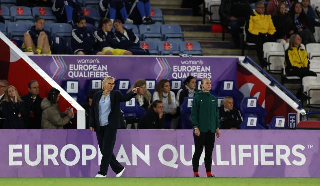 England's Dutch head coach Sarina Wiegman (L) gestures during the Women's FIFA world cup qualifications second leg semi-final football match between England and Greece at King Power stadium, in Leicester on October 13, 2026. (Photo by Darren Staples / AFP)