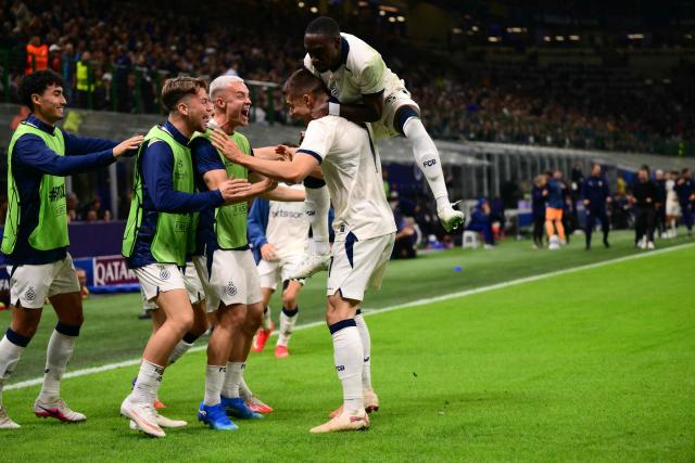 Club Brugge's German forward #07 Nicolo Tresoldi celebrates scoring his team's second goal with teammates during the UEFA Champions League first round day 2 football match between Inter Milan and Club Brugge at San Siro stadium in Milan, on October 13, 2026 (Photo by Marco BERTORELLO / AFP)