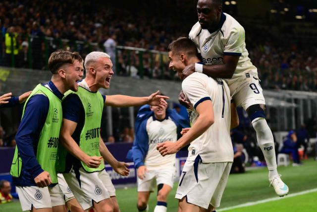 Club Brugge's German forward #07 Nicolo Tresoldi celebrates scoring his team's second goal with teammates during the UEFA Champions League first round day 2 football match between Inter Milan and Club Brugge at San Siro stadium in Milan, on October 13, 2026 (Photo by Marco BERTORELLO / AFP)