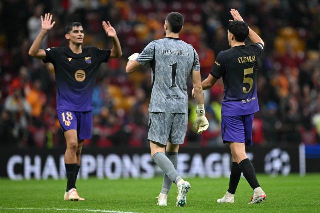 Barcelona's Spanish defender #18 Gerard Martin (L), Barcelona's Spanish goalkeeper #01 Joan Garcia (C) and Barcelona's Spanish defender #05 Pau Cubarsi (R) celebrate their team's victory at the end of the UEFA Champions League, league phase matchday 2, football match between Galatasaray and Barcelona at the Ali Sami Yen Sports Complex in Istanbul on October 13, 2026. (Photo by Ozan KOSE / AFP)