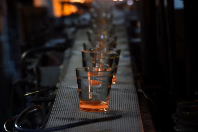 (FILES) Glasses are pictured on the production line at a factory of French manufacturer of glassware Duralex in La Chapelle-Saint-Mesmin near Orleans, centre France, on July 1, 2021, during a visit of the French Junior Minister of Small and Medium Entreprises. (Photo by GUILLAUME SOUVANT / AFP)
