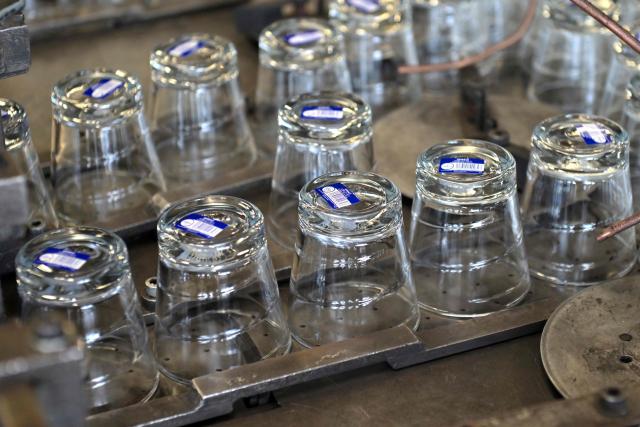(FILES) Glasses are pictured at the end of a production line at a factory of French manufacturer of glassware Duralex in La Chapelle-Saint-Mesmin near Orleans, centre France, on July 1, 2021, during a visit of the French Junior Minister of Small and Medium Entreprises. (Photo by GUILLAUME SOUVANT / AFP)