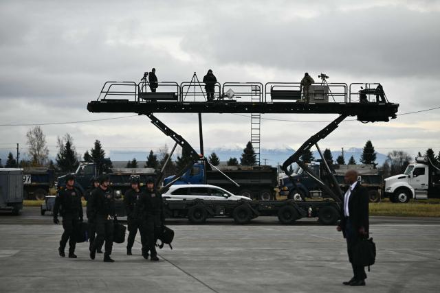 Security personnel are seen at Wasilla Airport in Wasilla, Alaska, on October 13, 2026. US President Donald Trump is in Alaska to hold a campaign rally ahead of the midterm elections. (Photo by Kent NISHIMURA / AFP)