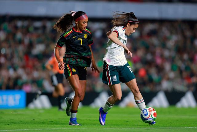 Jamaica’s defender #7 Mimi Van Zanten and Mexico's forward #11 Lizbeth Ovalle fight for the ball during the women's international friendly football match between Mexico and Jamaica at La Corregidora Stadium in Santiago de Queretaro, Queretaro State, Mexico on October 13, 2026. (Photo by Cesar Gomez / AFP)