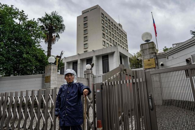 A police officer stands guard outside the Russian Embassy in Tokyo on October 14, 2026. Tokyo said October 14 it had urged Moscow to ensure "fair and impartial treatment" for a Japanese journalist who was arrested by Russia on suspicion of espionage. (Photo by Yuichi YAMAZAKI / AFP)