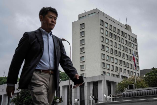 A man walks past the Russian Embassy in Tokyo on October 14, 2026. Tokyo said October 14 it had urged Moscow to ensure "fair and impartial treatment" for a Japanese journalist who was arrested by Russia on suspicion of espionage. (Photo by Yuichi YAMAZAKI / AFP)