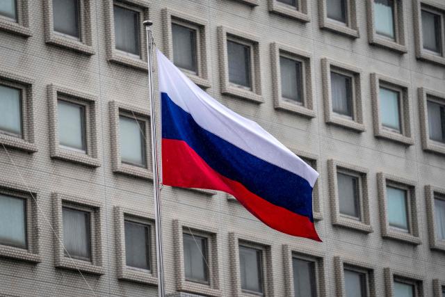 Russia's national flag is seen at the Russian Embassy in Tokyo on October 14, 2026. Tokyo said October 14 it had urged Moscow to ensure "fair and impartial treatment" for a Japanese journalist who was arrested by Russia on suspicion of espionage. (Photo by Yuichi YAMAZAKI / AFP)