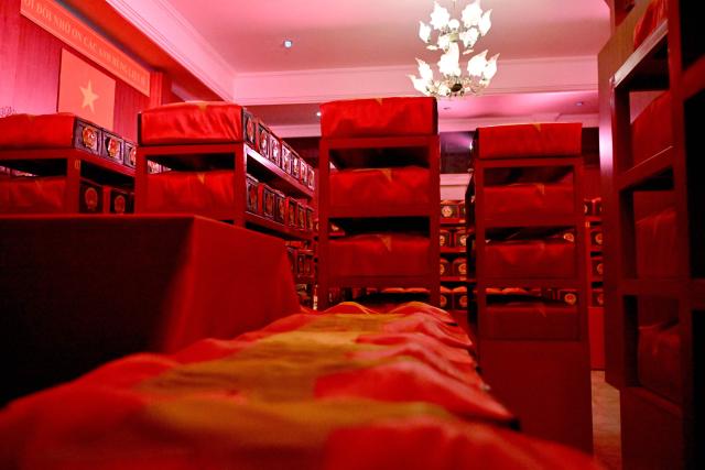 Caskets containing the remains of fallen soldiers are seen inside a holding room at Le Thi Rieng Park in Ho Chi Minh City on October 13, 2026. Vietnam held funeral rites for more than 700 of its war dead on October 14, unearthed in a major push to identify those missing from decades of conflict with France and the United States. (Photo by Nhac NGUYEN / AFP)
