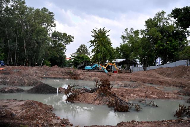 An excavation site for the remains of fallen soldiers at Le Thi Rieng Park is seen in Ho Chi Minh City on October 12, 2026. Vietnam held funeral rites for more than 700 of its war dead on October 14, unearthed in a major push to identify those missing from decades of conflict with France and the United States. (Photo by Nhac NGUYEN / AFP)