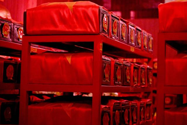 Caskets containing the remains of fallen soldiers are seen inside a holding room at Le Thi Rieng Park in Ho Chi Minh City on October 13, 2026. Vietnam held funeral rites for more than 700 of its war dead on October 14, unearthed in a major push to identify those missing from decades of conflict with France and the United States. (Photo by Nhac NGUYEN / AFP)