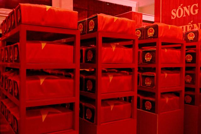 Caskets containing the remains of fallen soldiers are seen inside a holding room at Le Thi Rieng Park in Ho Chi Minh City on October 13, 2026. Vietnam held funeral rites for more than 700 of its war dead on October 14, unearthed in a major push to identify those missing from decades of conflict with France and the United States. (Photo by Nhac NGUYEN / AFP)